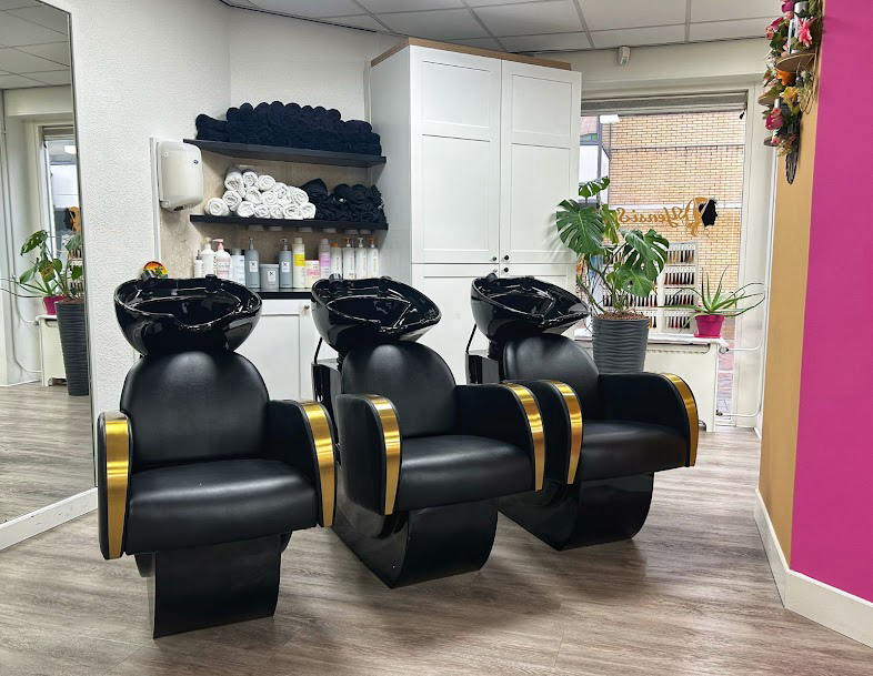 Triple wash basin area with black & gold chairs