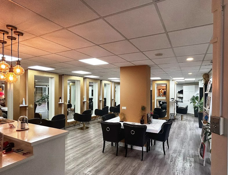 Open salon floor with stylist stations and lounge seating